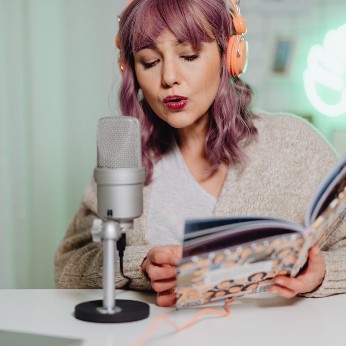 Woman recording a sponsored host read for her podcast